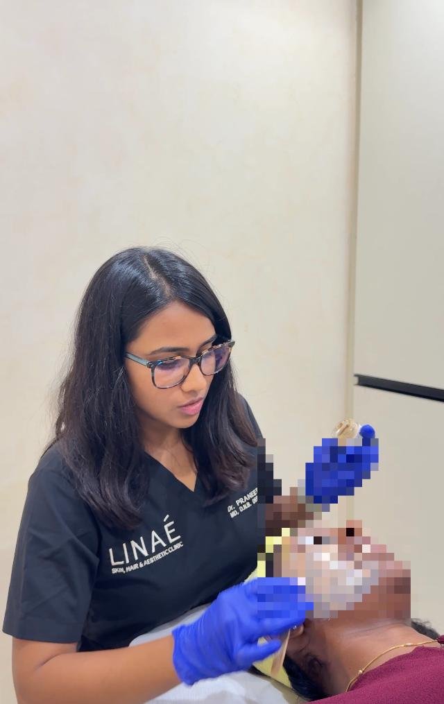 Dr. Praneeta Jain applying a medical-grade chemical peel for acne
