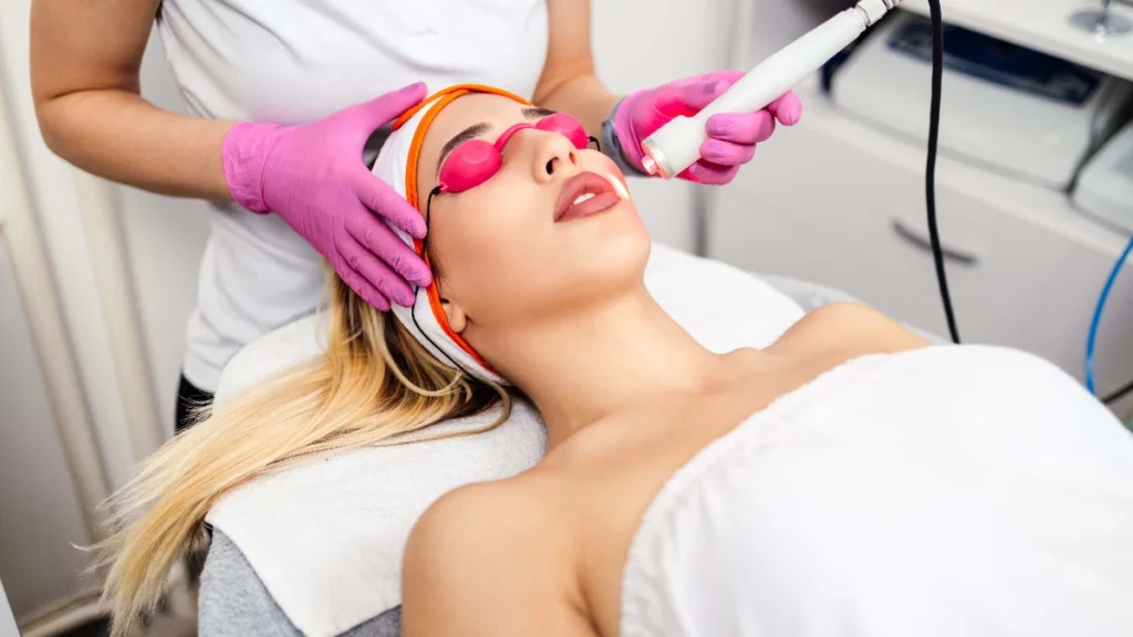 Laser hair reduction being performed on the face, with the patient wearing protective eyewear